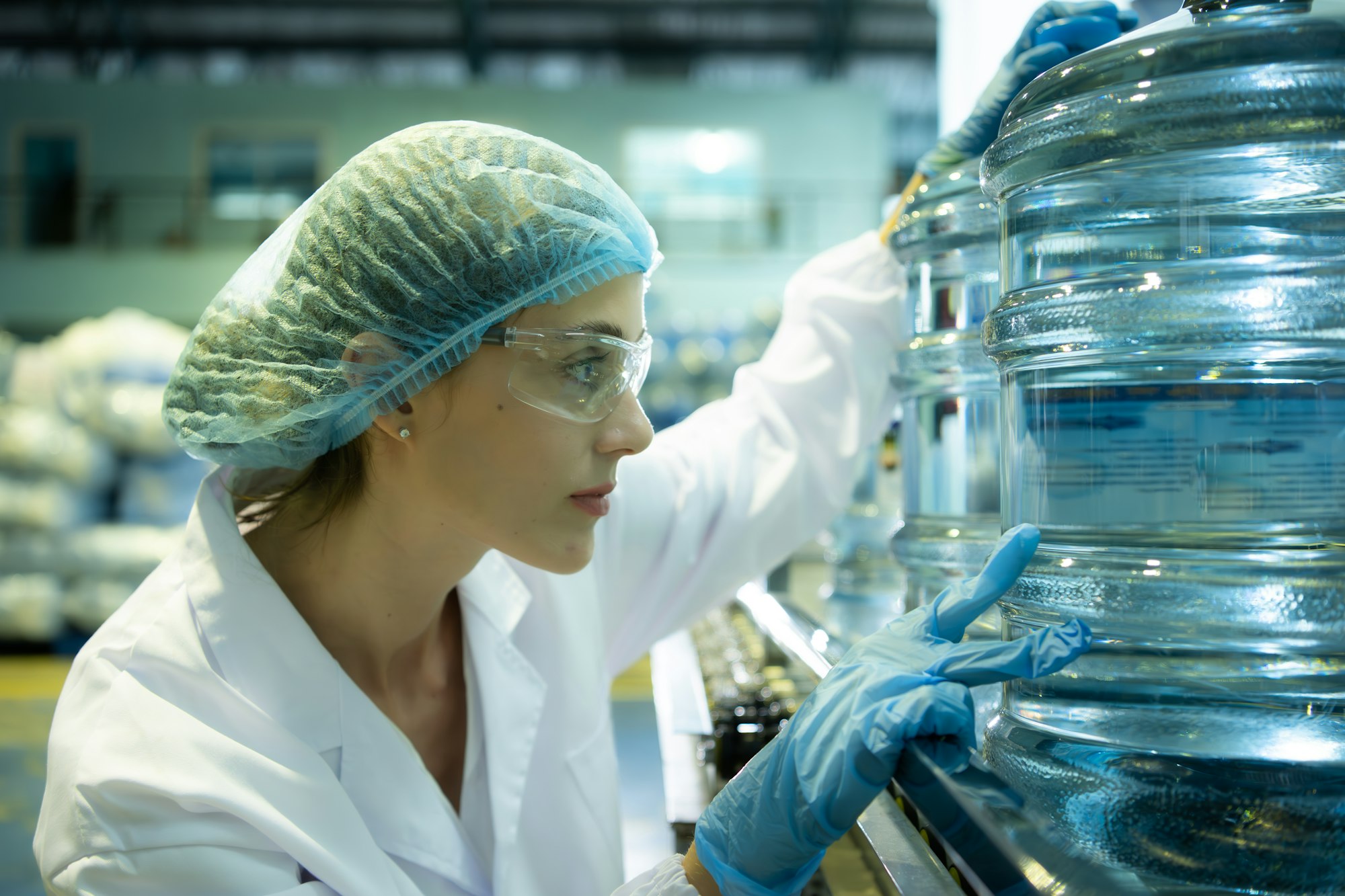Female quality control workers in a drinking water factory Inspecting the quality of water